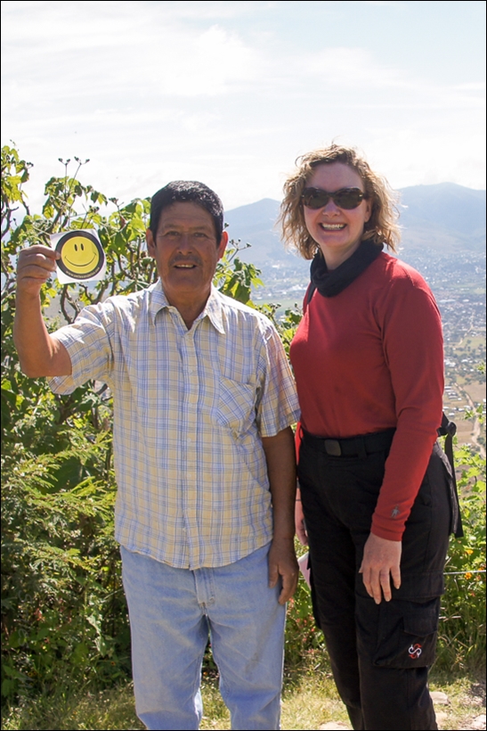 Tracey sharing a Smiles & Miles sticker with a local artisan. 